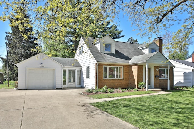 cape cod-style house with a garage, a front lawn, a chimney, brick siding, and concrete driveway