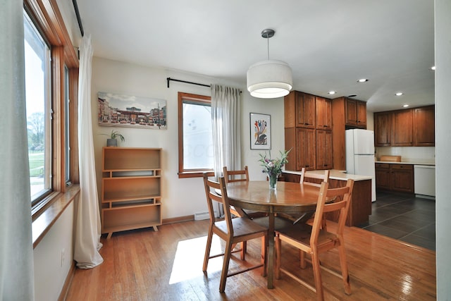 dining room with plenty of natural light, recessed lighting, and dark wood-style flooring