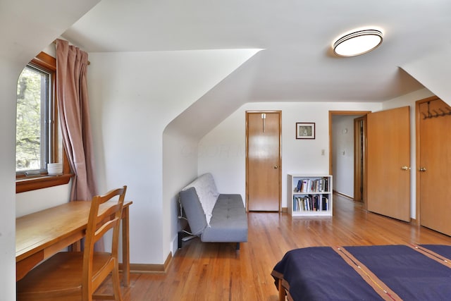 bedroom with baseboards and light wood-style flooring