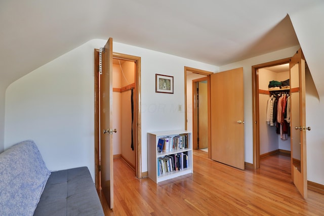 interior space featuring baseboards and light wood finished floors