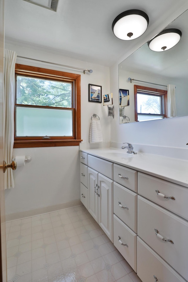 bathroom featuring vanity and baseboards
