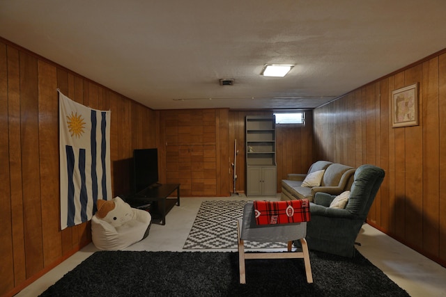 living area featuring visible vents, wooden walls, and light carpet