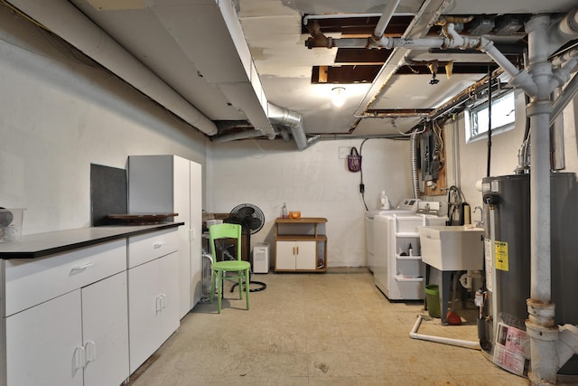 below grade area with a sink, separate washer and dryer, gas water heater, and light floors