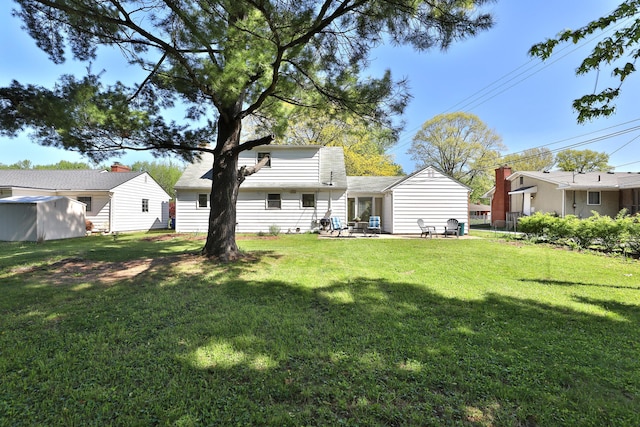 rear view of property with a patio and a yard