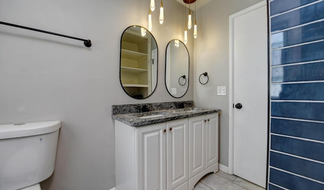 4589 Annhurst Rd, Columbus, OH 43228 - bathroom with toilet, double vanity, tile patterned flooring, and baseboards