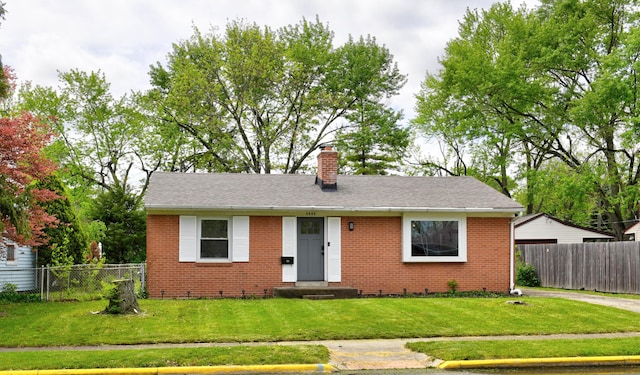 4589 Annhurst Rd, Columbus, OH 43228 - view of front of house with a chimney, brick siding, roof with shingles, and entry steps