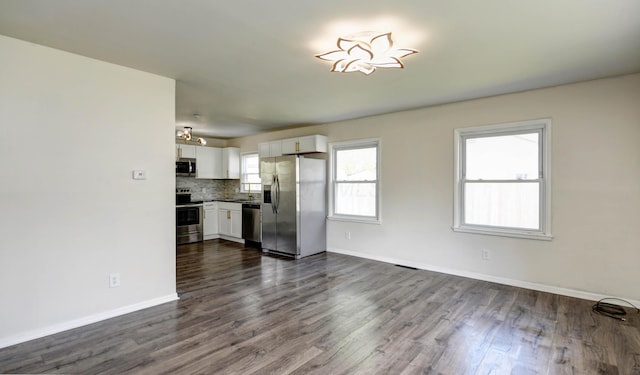 4589 Annhurst Rd, Columbus, OH 43228 - unfurnished living room featuring dark wood-type flooring, baseboards, and a sink