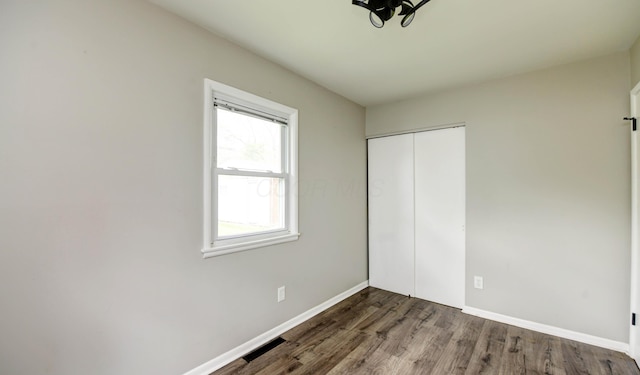 4589 Annhurst Rd, Columbus, OH 43228 - unfurnished bedroom with wood finished floors, baseboards, and a closet