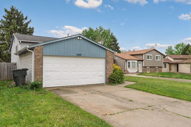 tri-level home featuring brick siding, an attached garage, and concrete driveway
