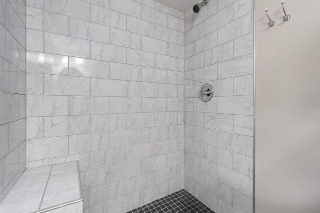 bathroom featuring a tile shower