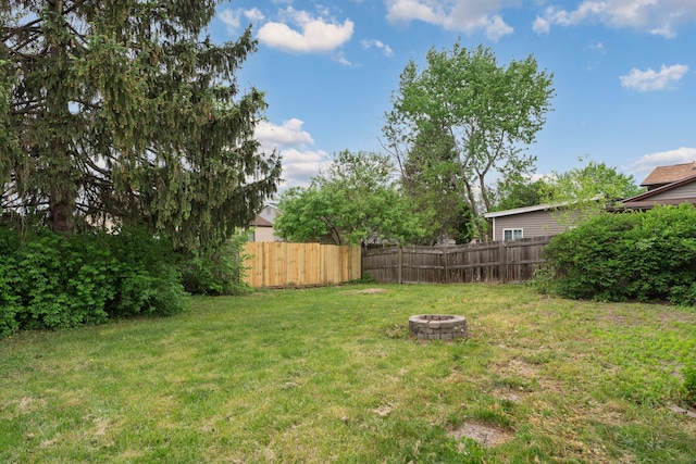 view of yard with an outdoor fire pit