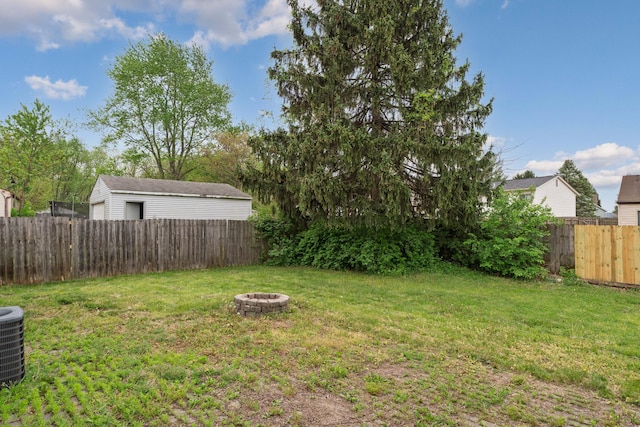 view of yard featuring an outdoor fire pit and cooling unit