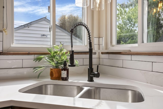 details with light countertops, a sink, and tasteful backsplash