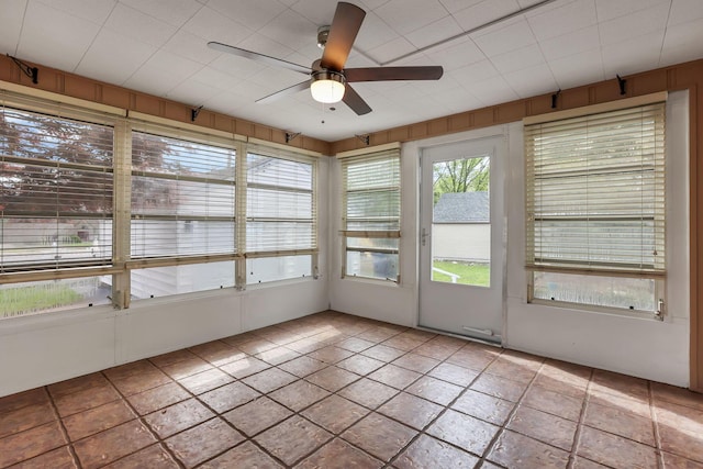 unfurnished sunroom with ceiling fan