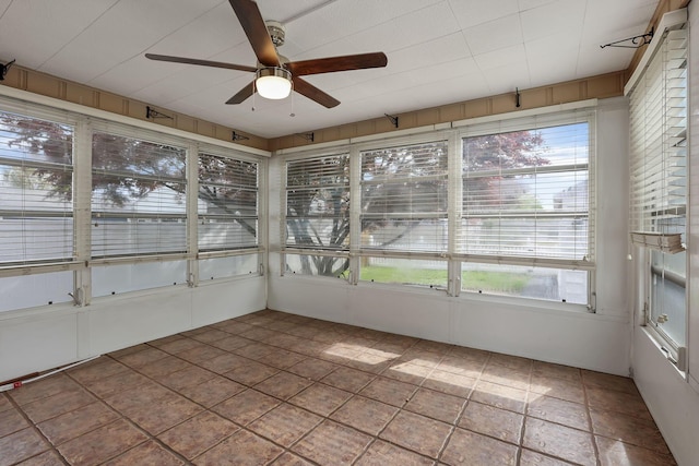 unfurnished sunroom featuring a ceiling fan