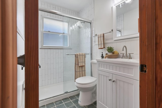 full bathroom featuring vanity, tile patterned floors, a shower stall, and toilet