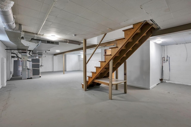 basement featuring stairway and water heater