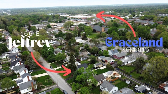 aerial view featuring a forest view and a residential view