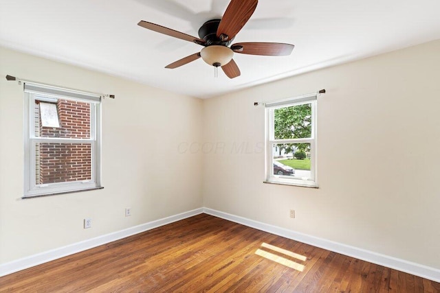 spare room featuring baseboards, a ceiling fan, and wood finished floors