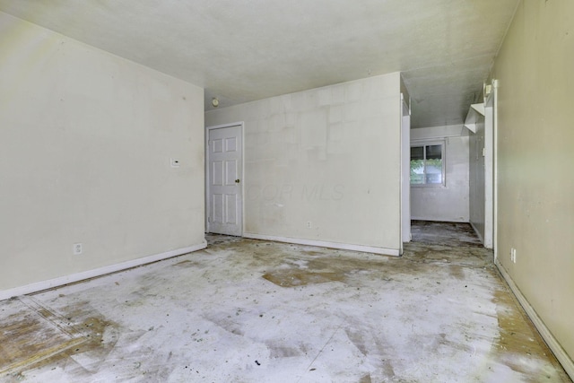 5143 Rutledge Dr N, Columbus, OH 43232 - empty room with baseboards and concrete flooring