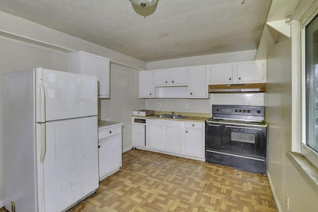 5143 Rutledge Dr N, Columbus, OH 43232 - kitchen featuring a sink, white cabinets, freestanding refrigerator, under cabinet range hood, and black range with electric cooktop
