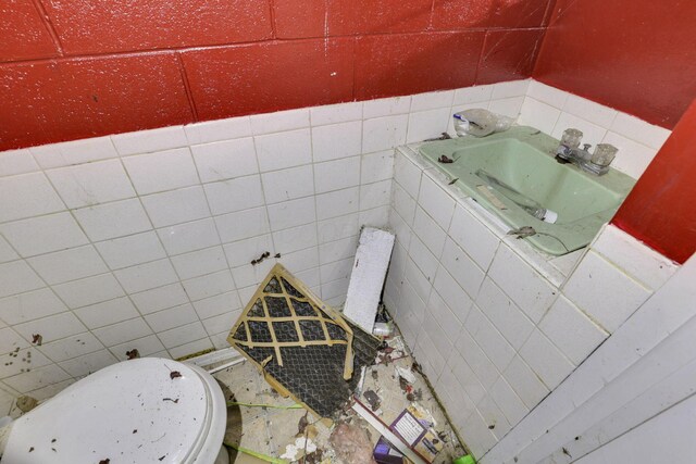 5143 Rutledge Dr N, Columbus, OH 43232 - half bath with a sink, tile walls, and toilet
