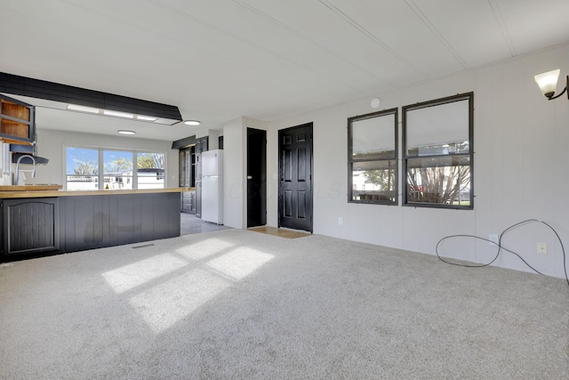 unfurnished living room featuring visible vents and carpet