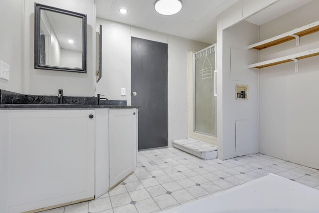 bathroom with double vanity, recessed lighting, tile patterned floors, a sink, and a stall shower