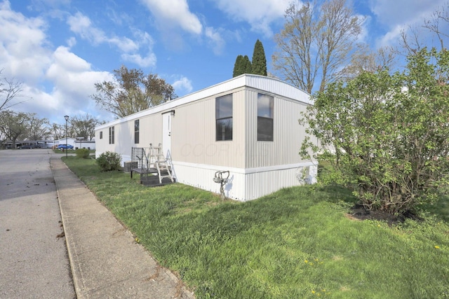 view of home's exterior featuring a yard