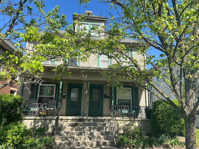 italianate-style house featuring a porch
