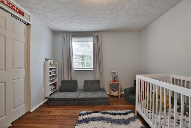 bedroom with wood finished floors and a textured ceiling