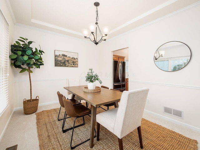 5068 Shadow Woods Ct, Powell, OH 43065 - dining area featuring a chandelier, a tray ceiling, light colored carpet, baseboards, and crown molding