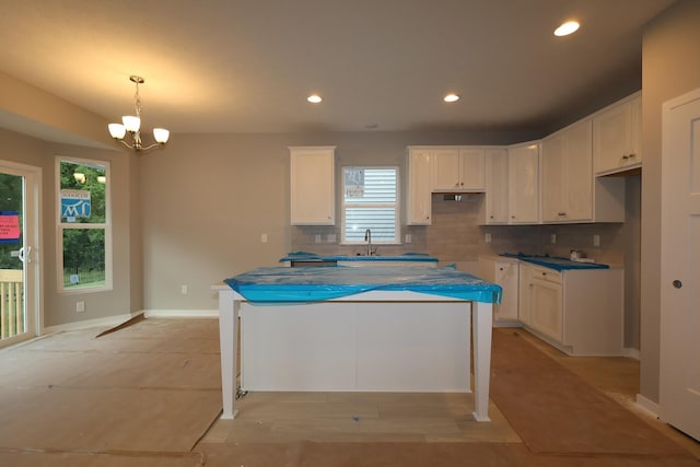 378 Canterbury Rd, Commercial Point, OH 43116 - kitchen with tasteful backsplash, white cabinets, a chandelier, recessed lighting, and a kitchen island