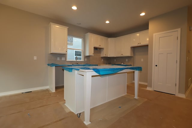 378 Canterbury Rd, Commercial Point, OH 43116 - kitchen with white cabinets, a kitchen island, backsplash, and recessed lighting