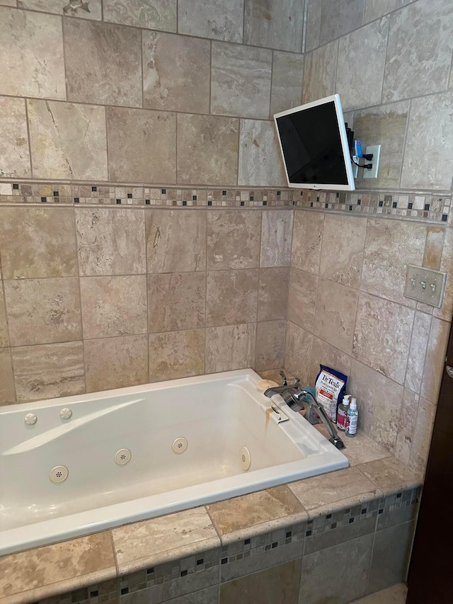 full bath with a tub with jets