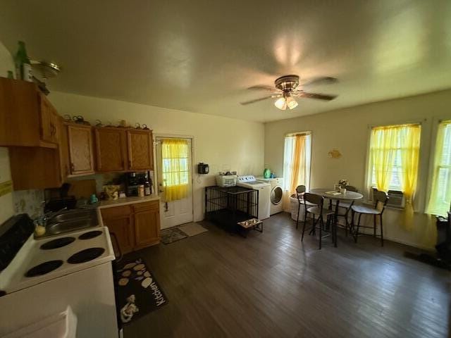 kitchen with plenty of natural light, independent washer and dryer, white range with electric stovetop, and ceiling fan