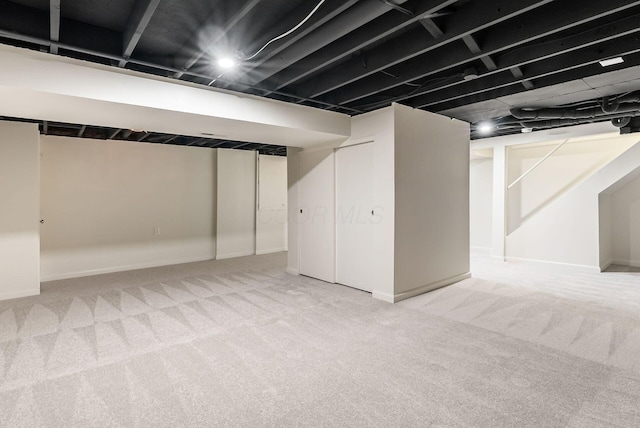 finished below grade area featuring carpet floors and baseboards