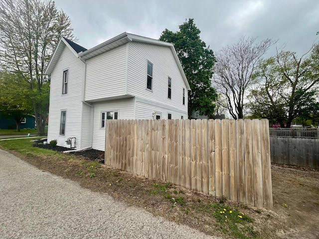 view of side of property featuring fence