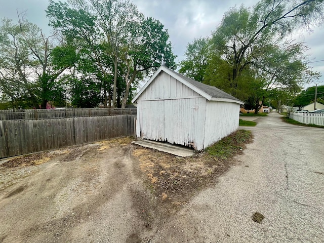 view of shed featuring fence