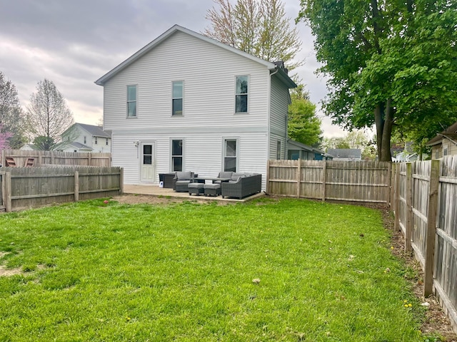 rear view of property with an outdoor living space, a fenced backyard, and a yard