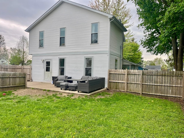 back of house featuring a patio, a fenced backyard, a yard, and an outdoor hangout area