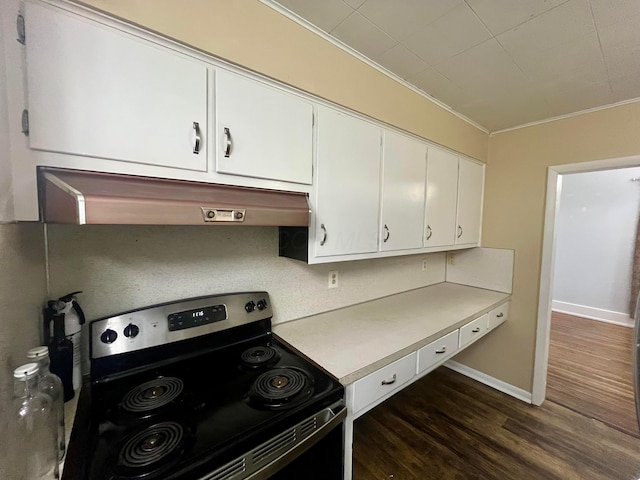 kitchen featuring crown molding, dark wood-type flooring, light countertops, stainless steel electric range, and under cabinet range hood