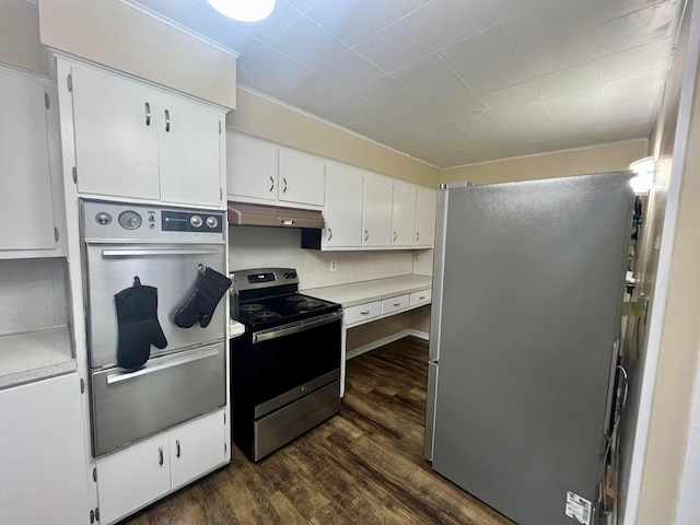 kitchen featuring dark wood-style floors, light countertops, under cabinet range hood, white cabinets, and appliances with stainless steel finishes