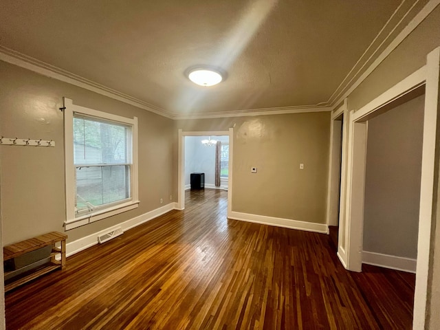 spare room with baseboards, an inviting chandelier, dark wood-style floors, and plenty of natural light