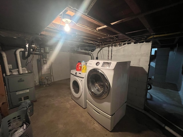 unfinished below grade area with heating unit, washer and clothes dryer, and water heater