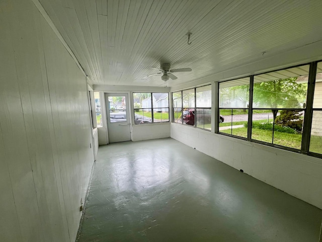 unfurnished sunroom with a ceiling fan