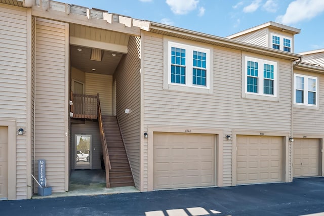view of property featuring an attached garage and driveway