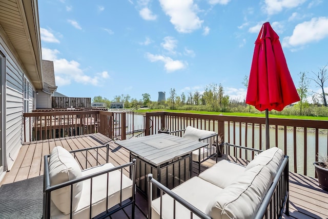 wooden deck featuring an outdoor hangout area and a water view