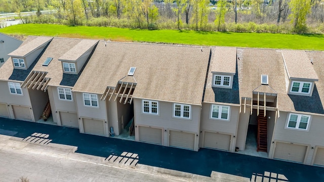 back of house featuring a garage and driveway