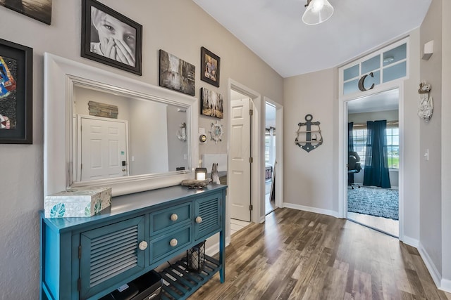 interior space with baseboards and dark wood finished floors